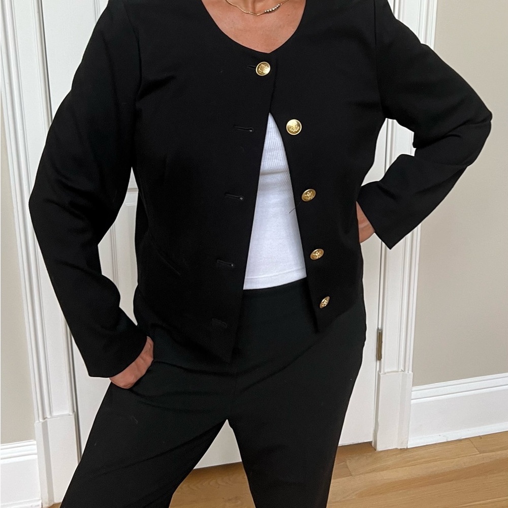 Cropped Mario Bellucci black blazer with gold decorative buttons in luxe knit.